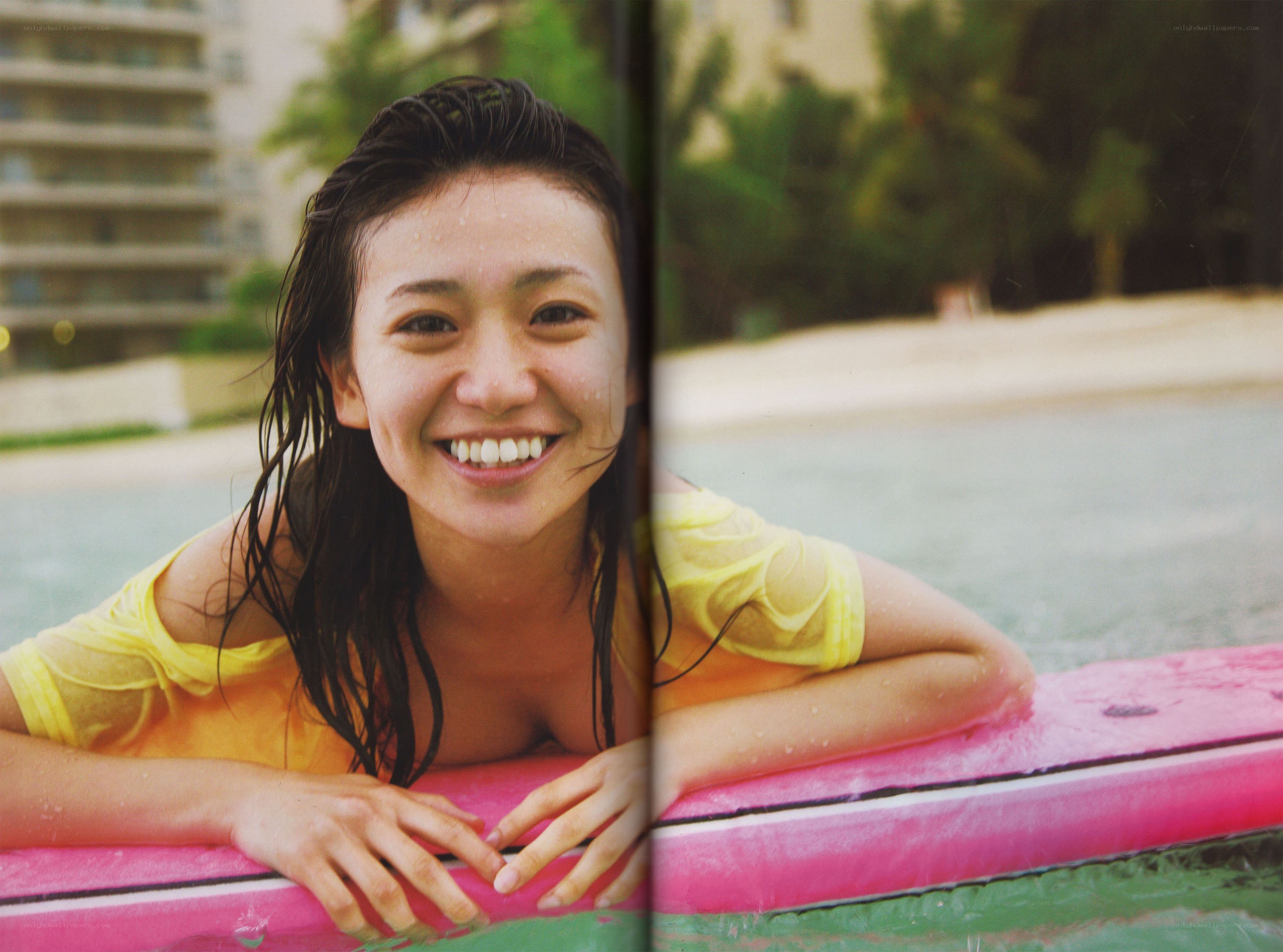 woman smiling on surfboard