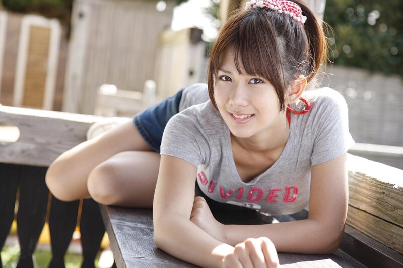 woman smiling on wooden bench
