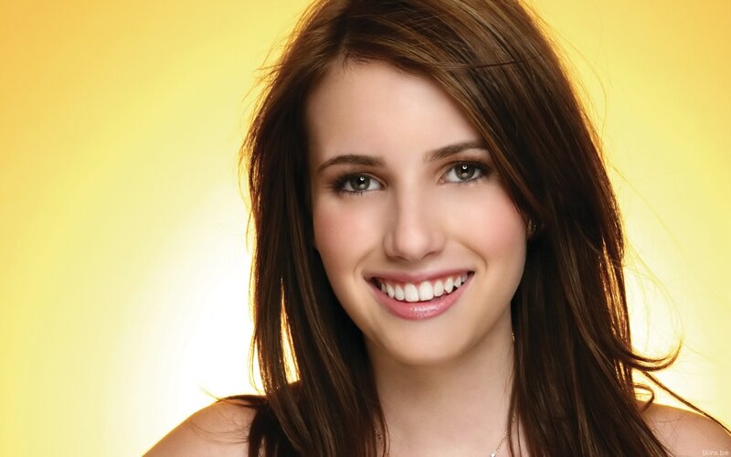 woman smiling on yellow background