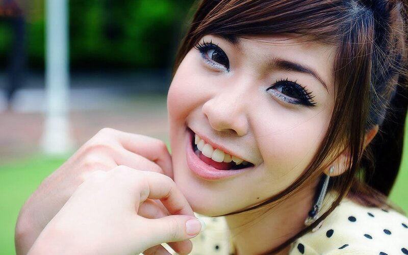 Woman Smiling Outdoors — Brown