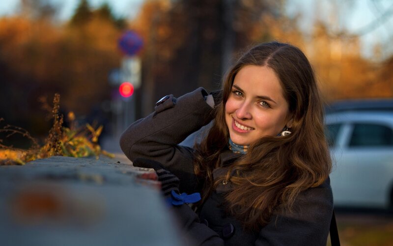 woman smiling outdoors in autumn