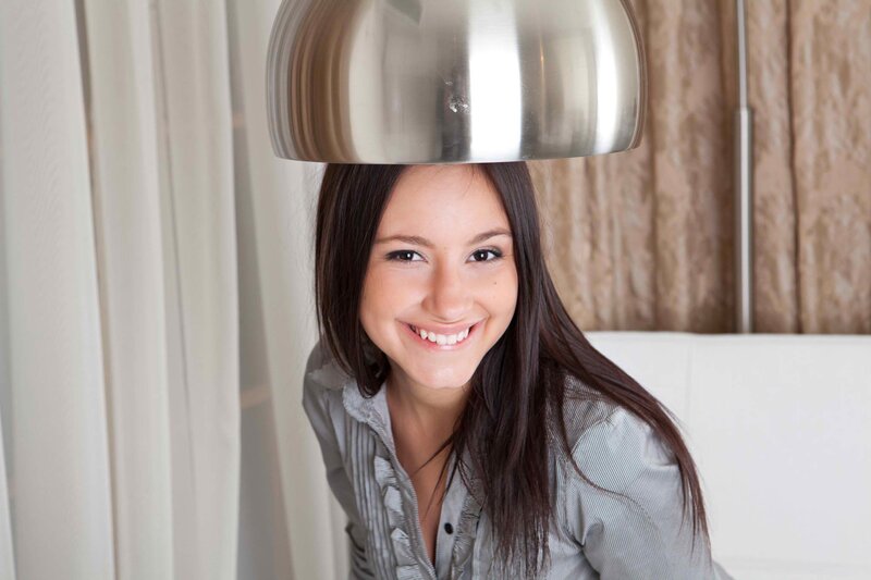 woman smiling under lamp