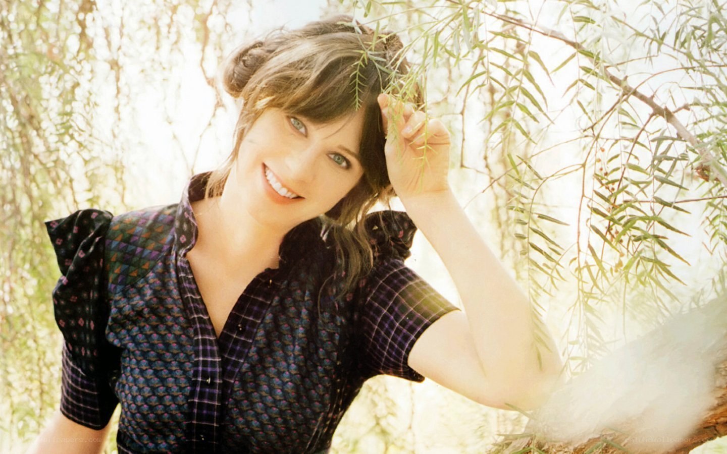 woman smiling under tree