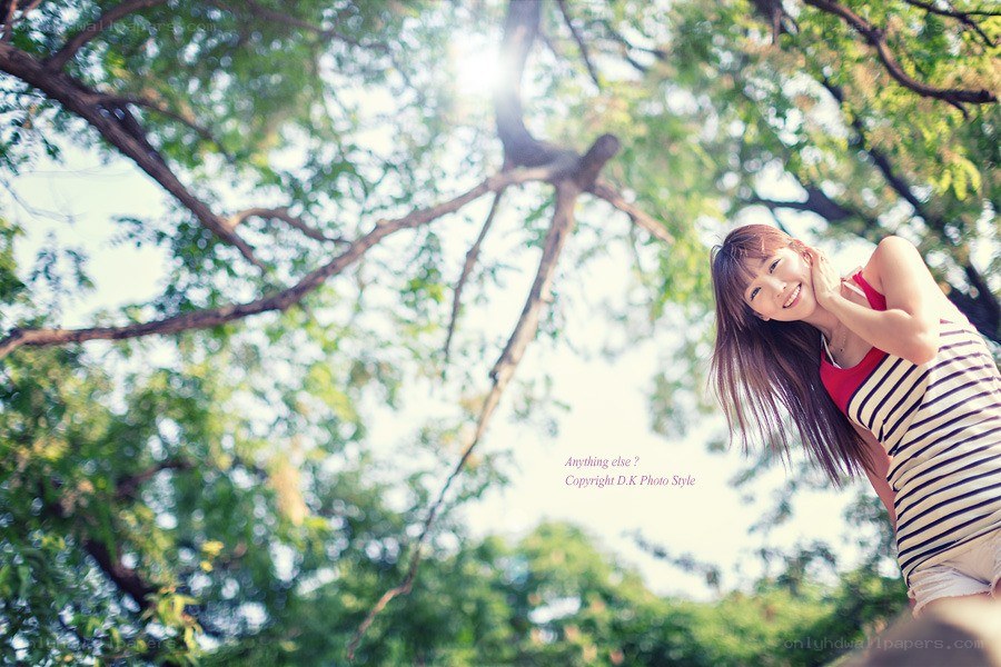Woman smiling under tree