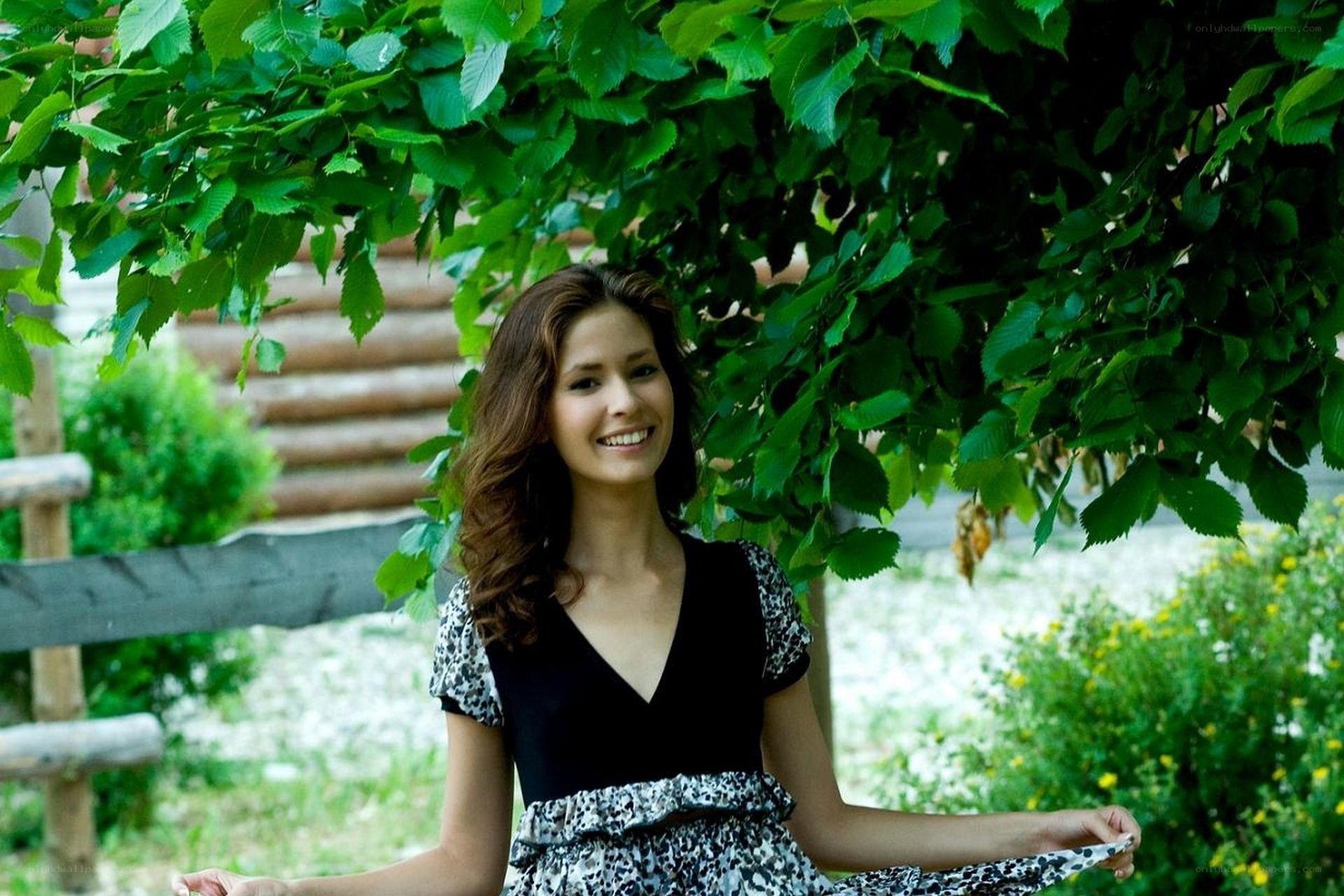 woman smiling under tree