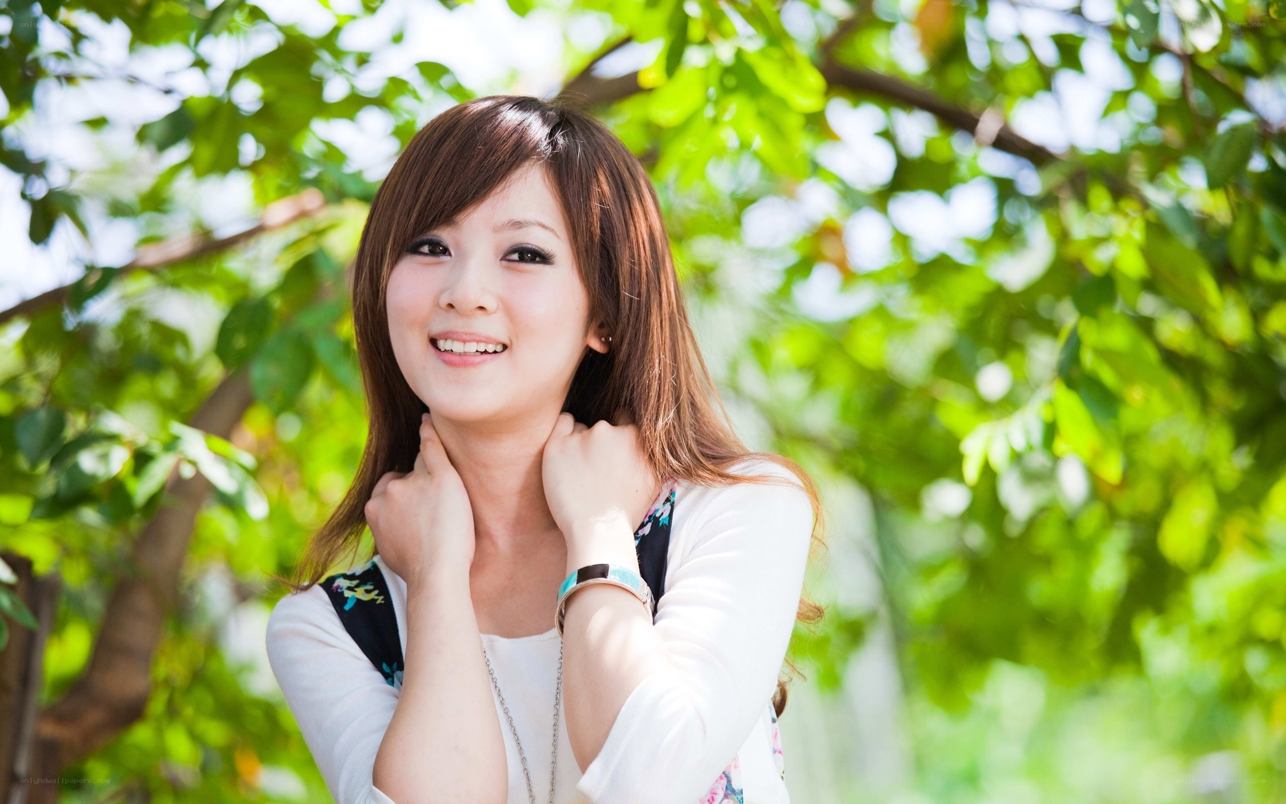 woman smiling under tree