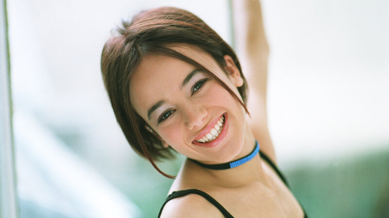 woman smiling with blue choker