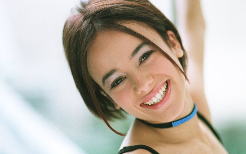 woman smiling with blue choker