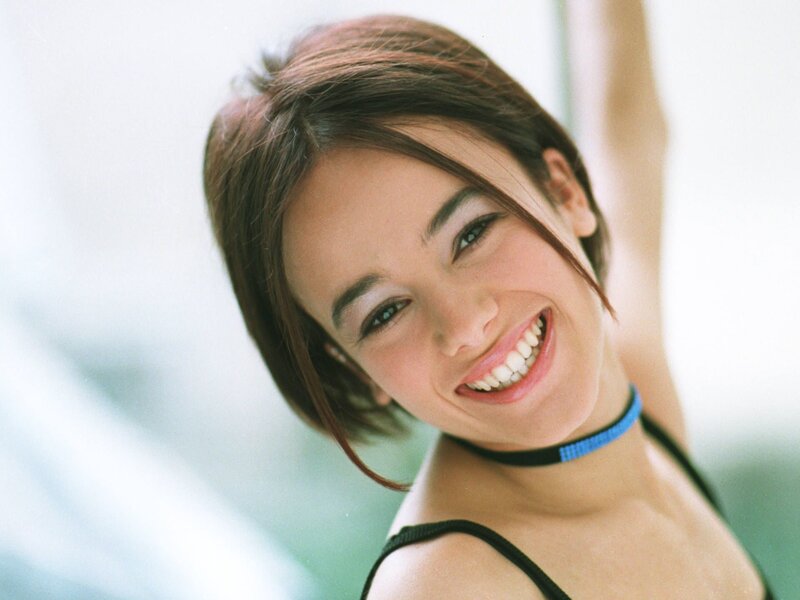woman smiling with blue choker