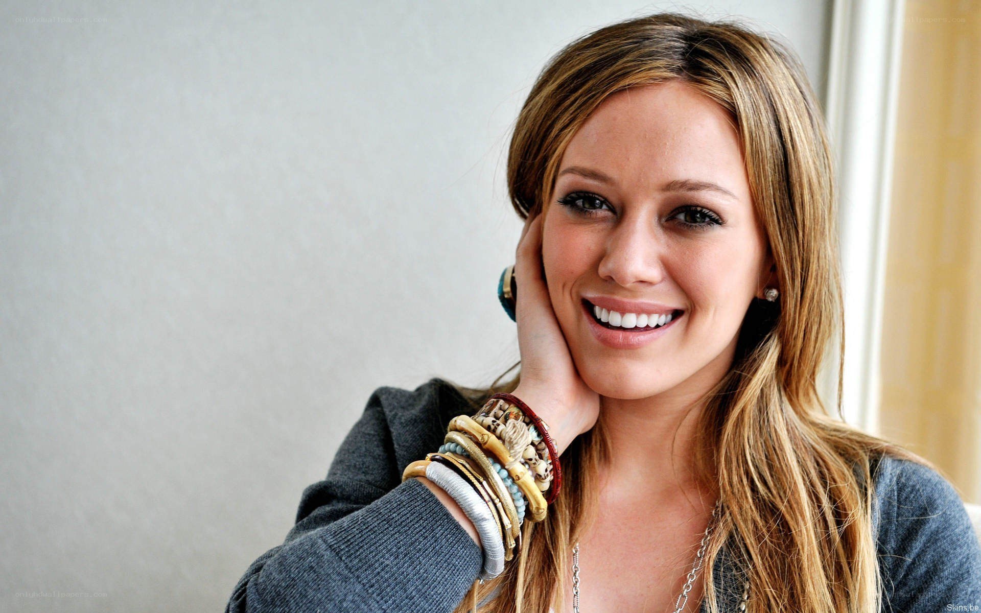 woman smiling with bracelets