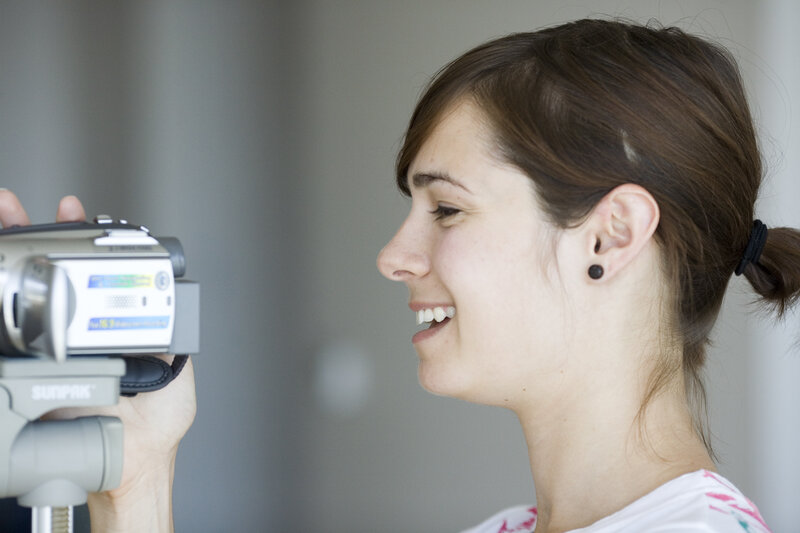 woman smiling with camcorder