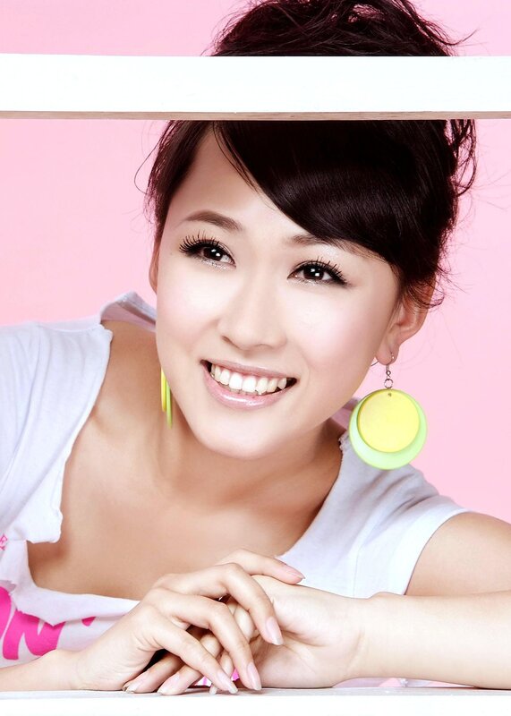 woman smiling with colorful earrings
