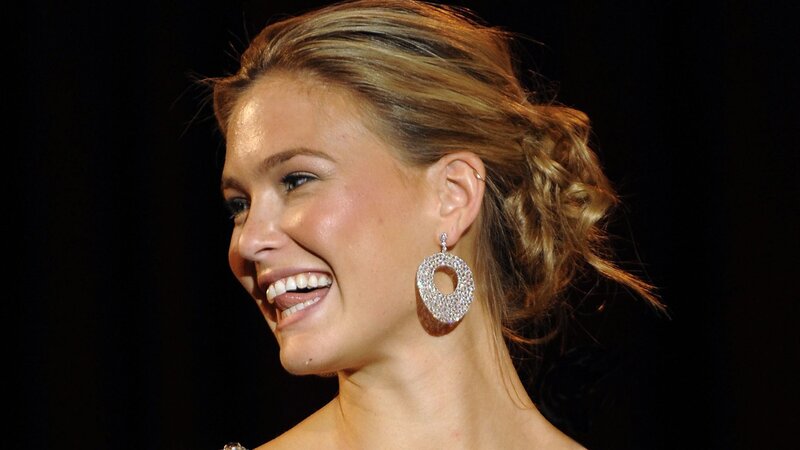 woman smiling with diamond earrings