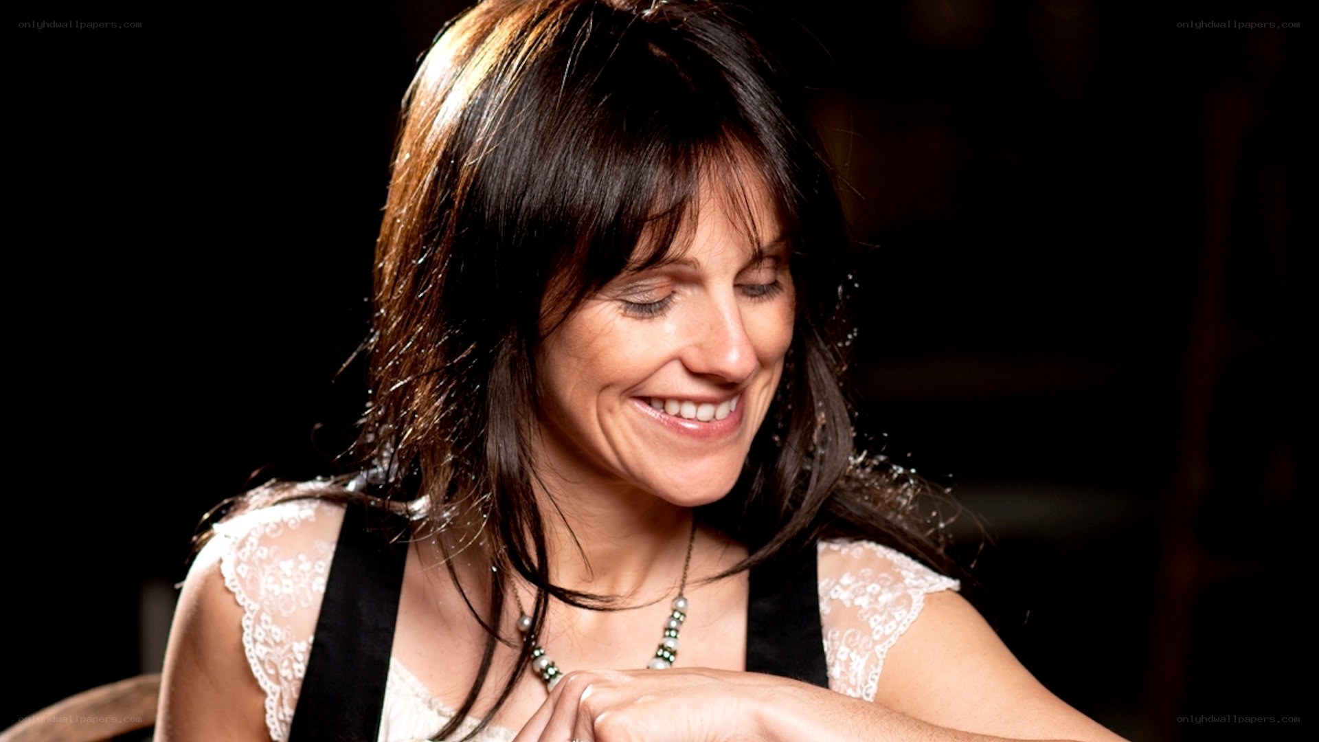 woman smiling with eyes closed