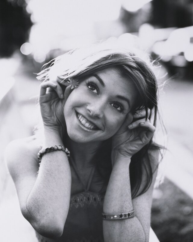 woman smiling with flower in hair