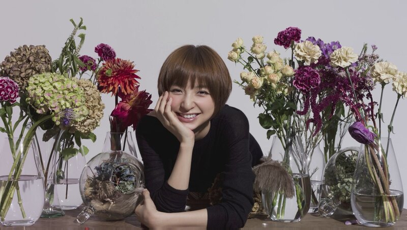woman smiling with flowers