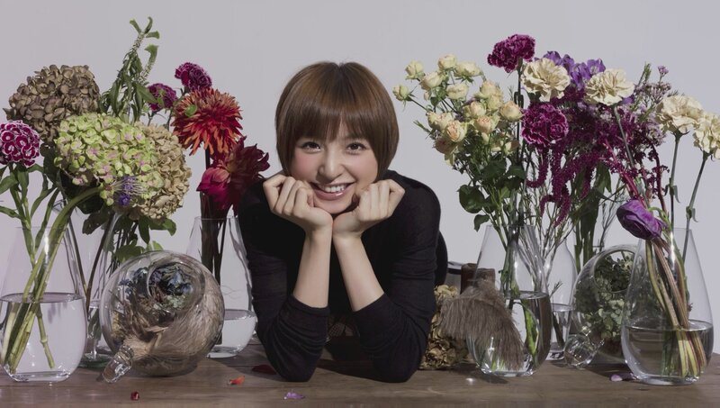 woman smiling with flowers