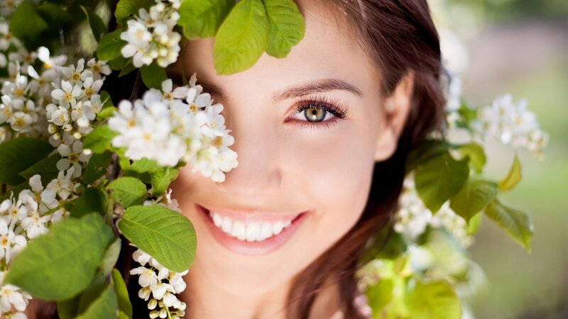 woman smiling with flowers