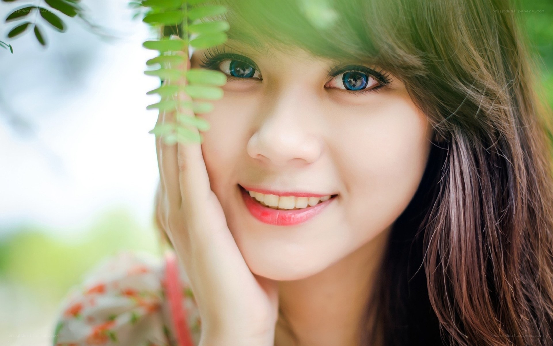 woman smiling with green leaf
