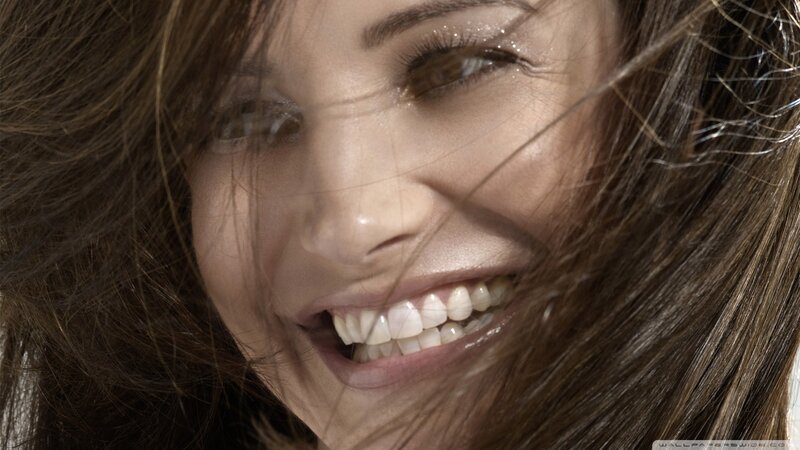 woman smiling with hair blowing