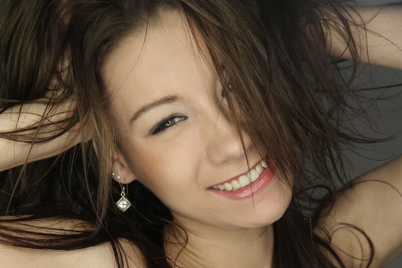 woman smiling with hair in face