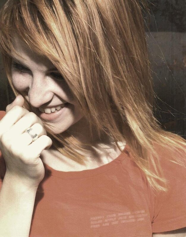 woman smiling with hand near face