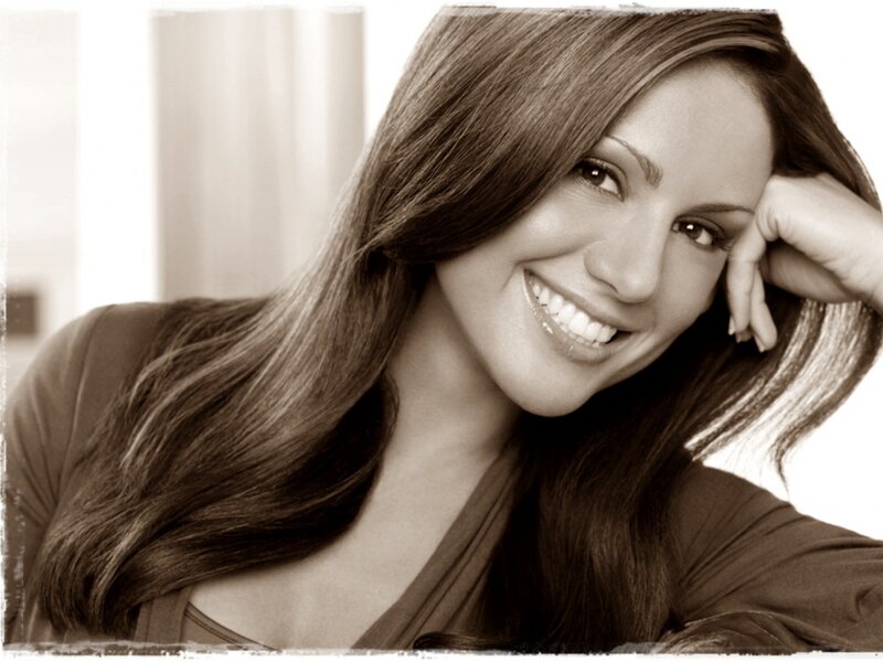 woman smiling with hand on cheek