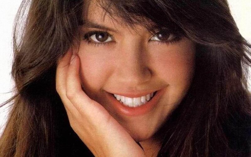 woman smiling with hand on cheek