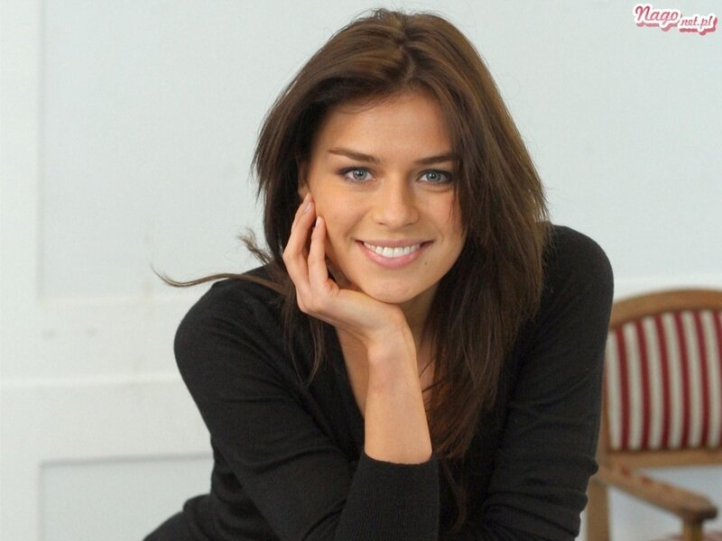 woman smiling with hand on cheek