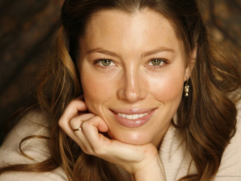 woman smiling with hand on chin