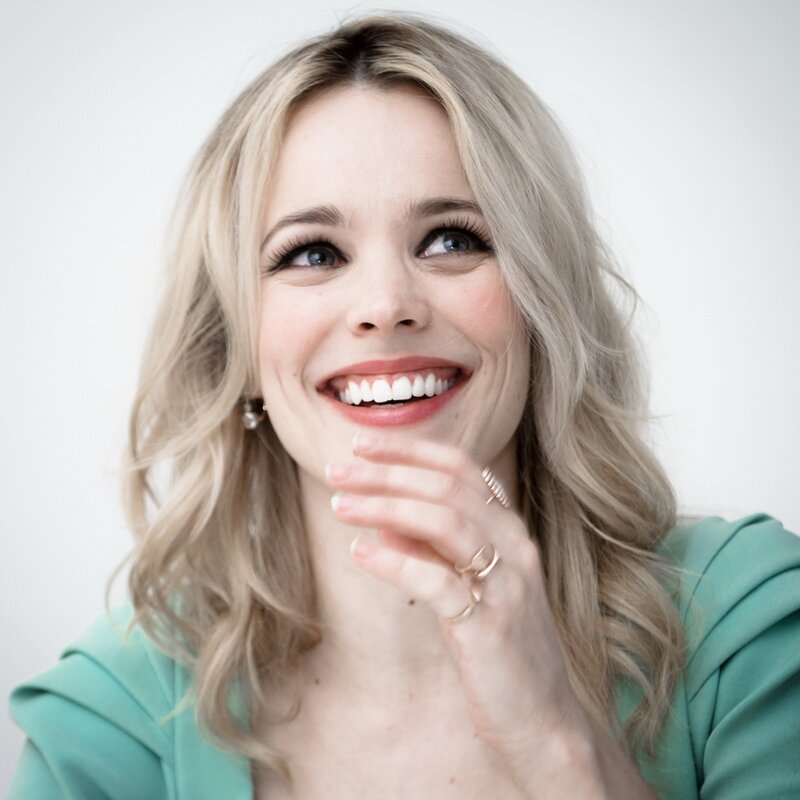 woman smiling with hand on chin