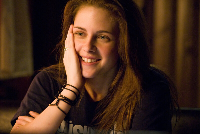 woman smiling with hand on face