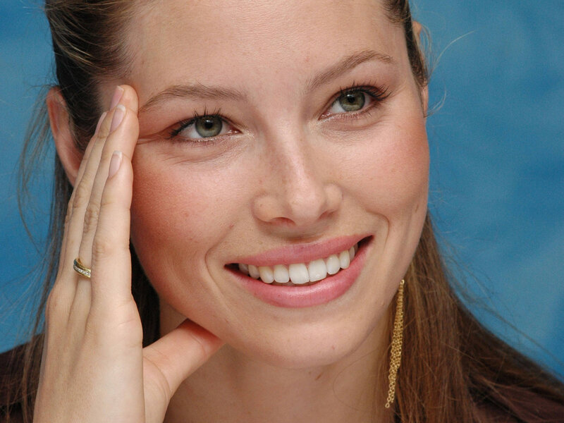Woman Smiling with Hand on Face — Blue