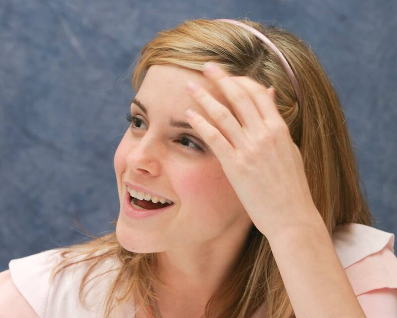 woman smiling with hand on forehead