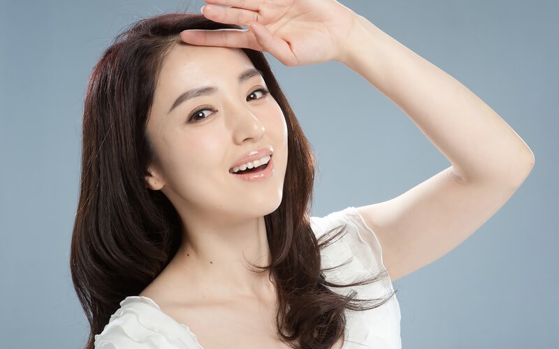 woman smiling with hand on forehead