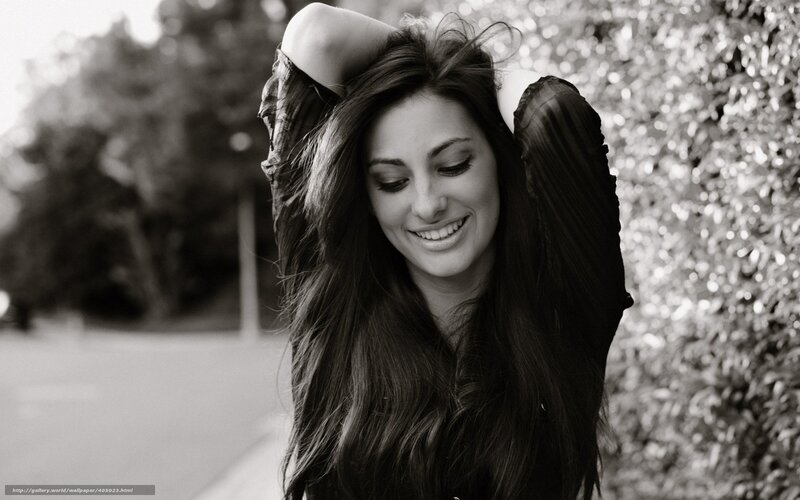 woman smiling with hands in hair