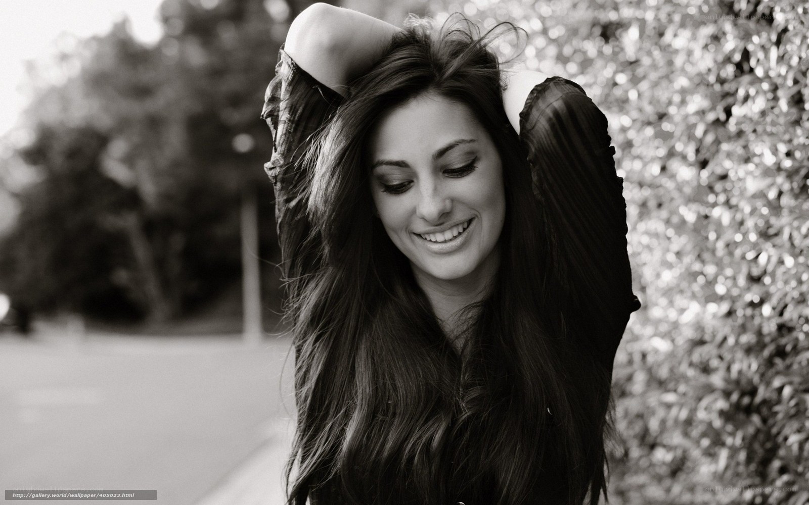 woman smiling with hands in hair