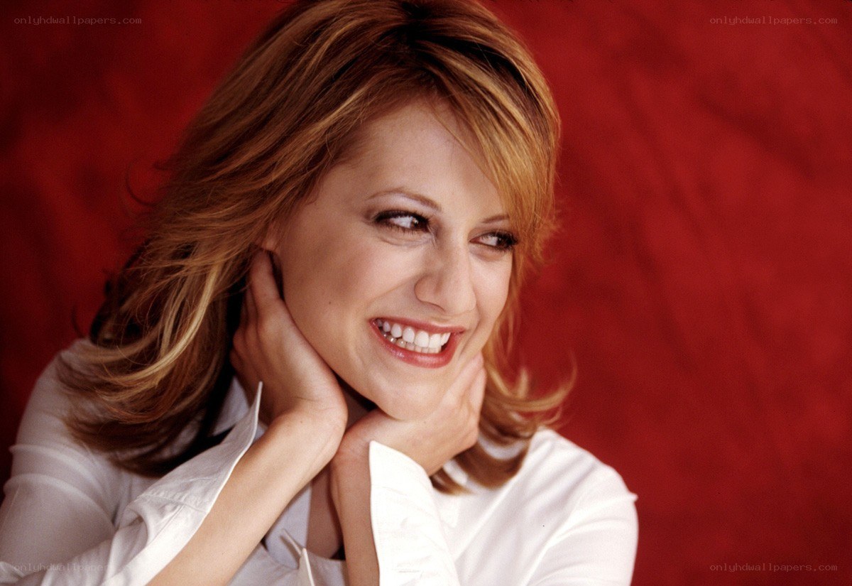 woman smiling with hands on cheeks