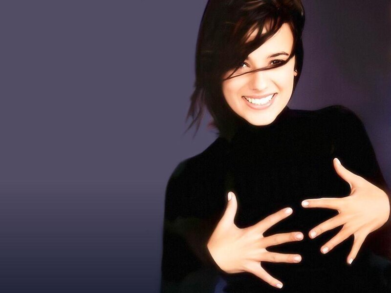 woman smiling with hands on chest