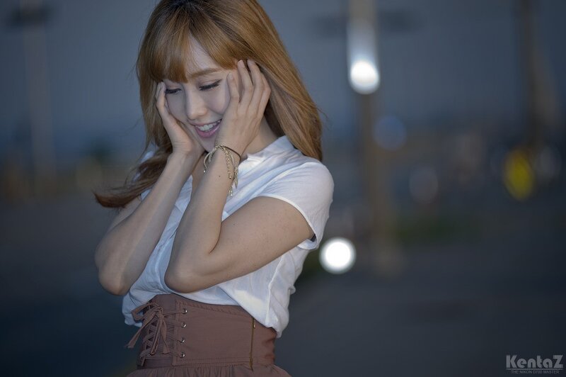 woman smiling with hands on face