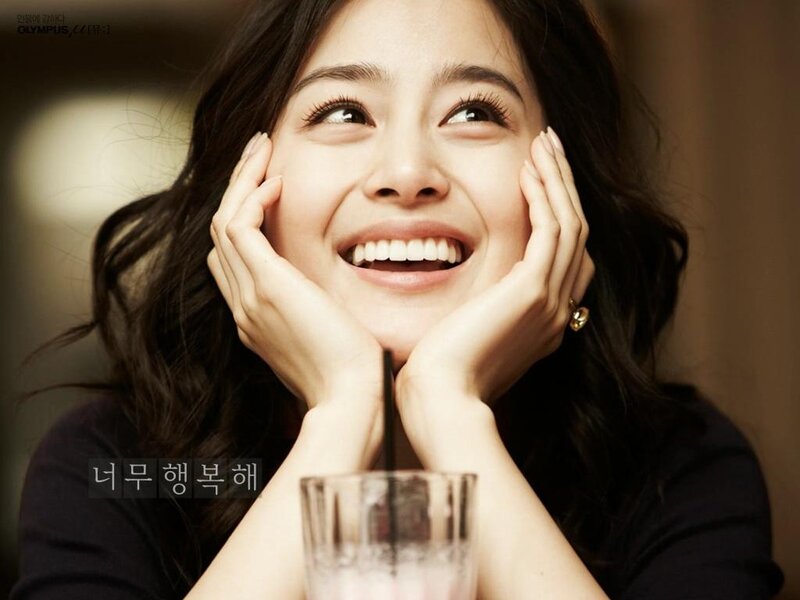 woman smiling with hands on face
