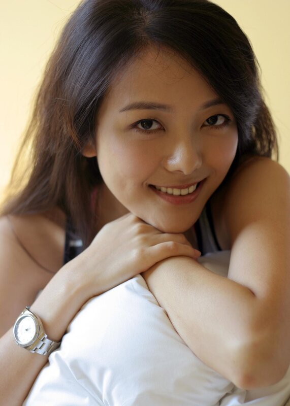 woman smiling with hands on pillow
