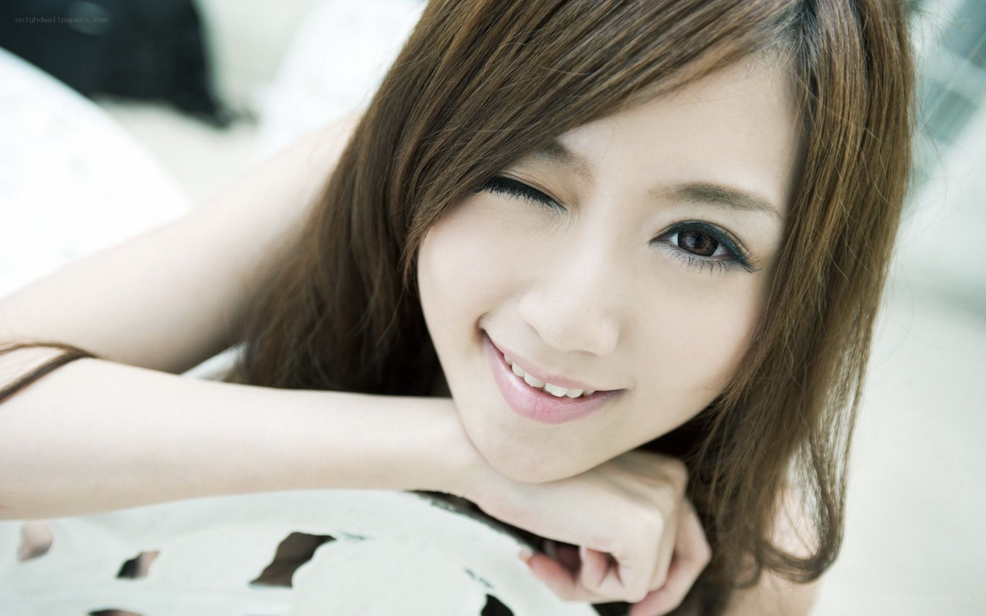 woman smiling with one eye closed