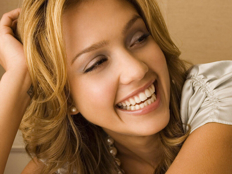 woman smiling with pearl earrings