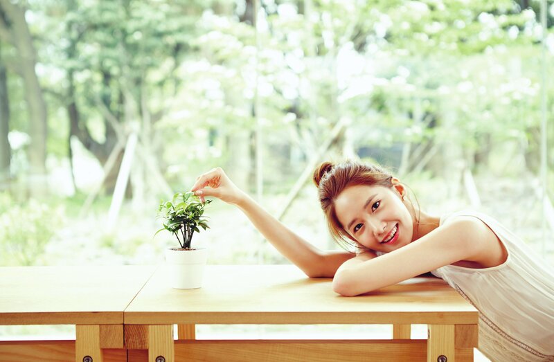 woman smiling with plant