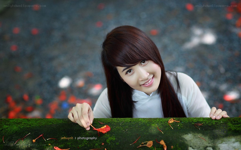 woman smiling with red leaf