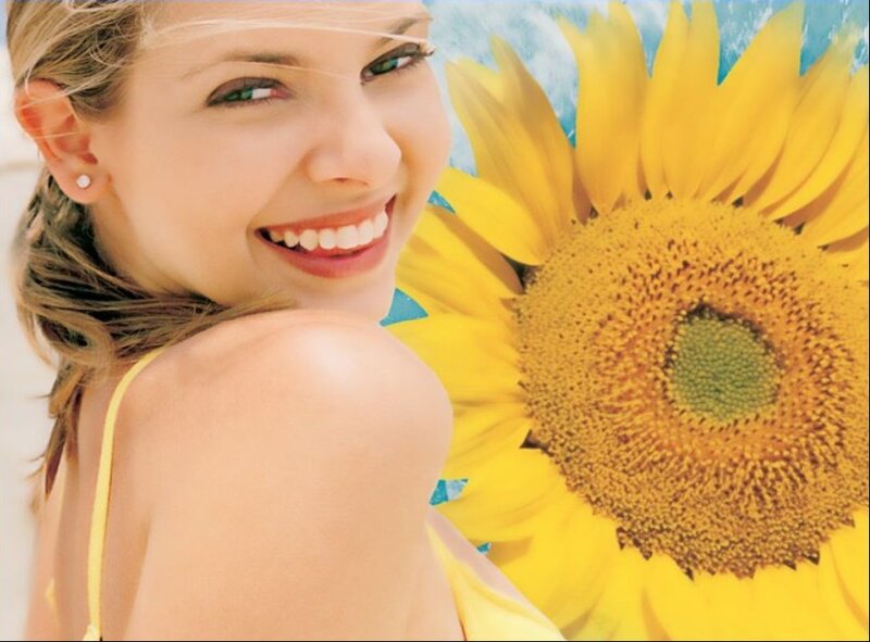 woman smiling with sunflower