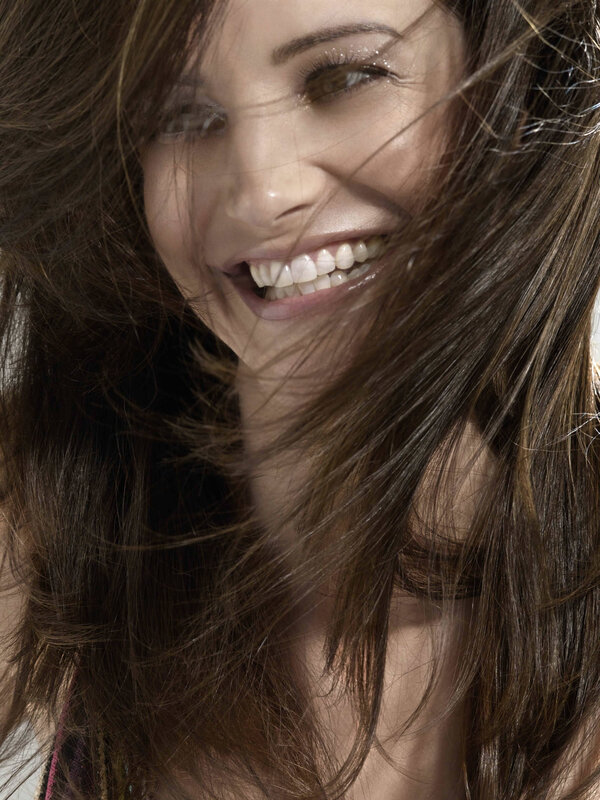 woman smiling with wind-blown hair