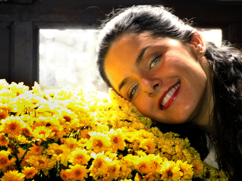 woman smiling with yellow flowers