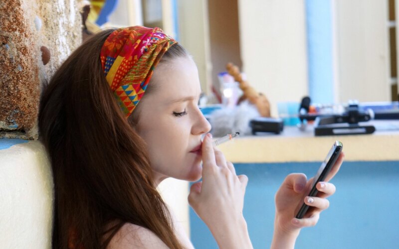 woman smoking and using phone